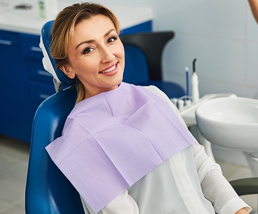 Woman smiling while sitting in treatment chair