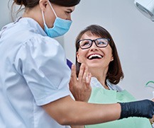 Dentist reviewing X-ray with smiling patient