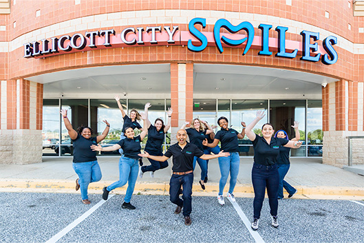 Group of smiling people running together