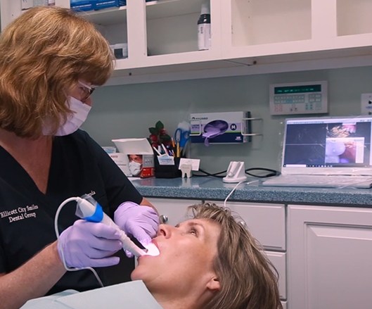 Dental team member using intraoral camera to capture smile images