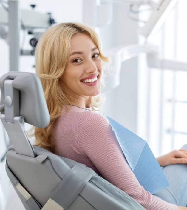 Happy dental patient looking over her shoulder