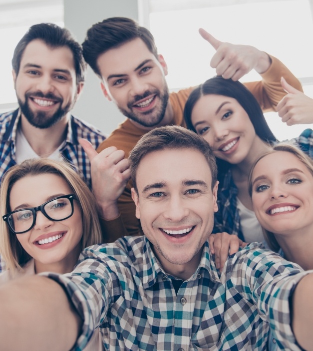 Group of friends sharing beautiful smiles after dental services