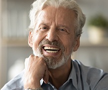 man smiling with dentures in Ellicott City