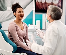 woman speaking with dentist about dentures in Ellicott City