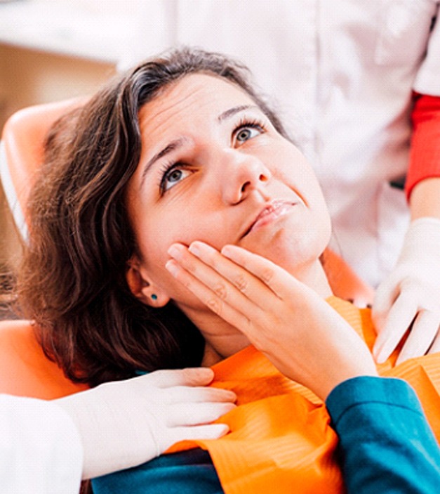 a person holding their mouth because their dental implant is loose