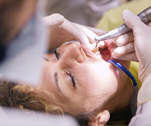 Dentist performing procedure for full mouth reconstruction.