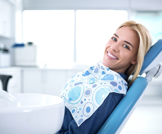 Woman with an attractive smile after full mouth reconstruction.