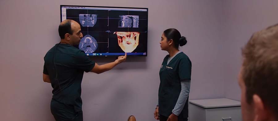 Ellicott City dentists showing a patient their dental x rays on computer screen