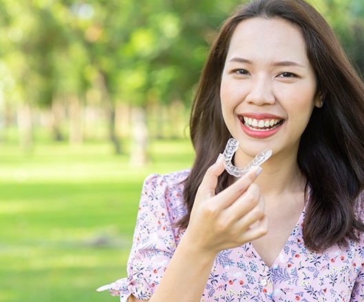 Woman placing Invisalign tray