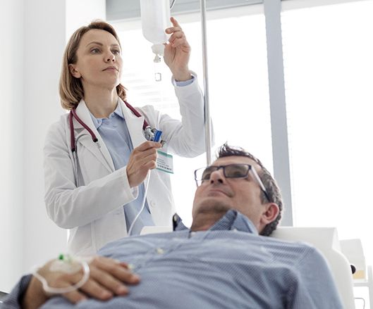 Dental team member preparing to administer IV sedation for patient