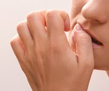 A woman biting her fingernails