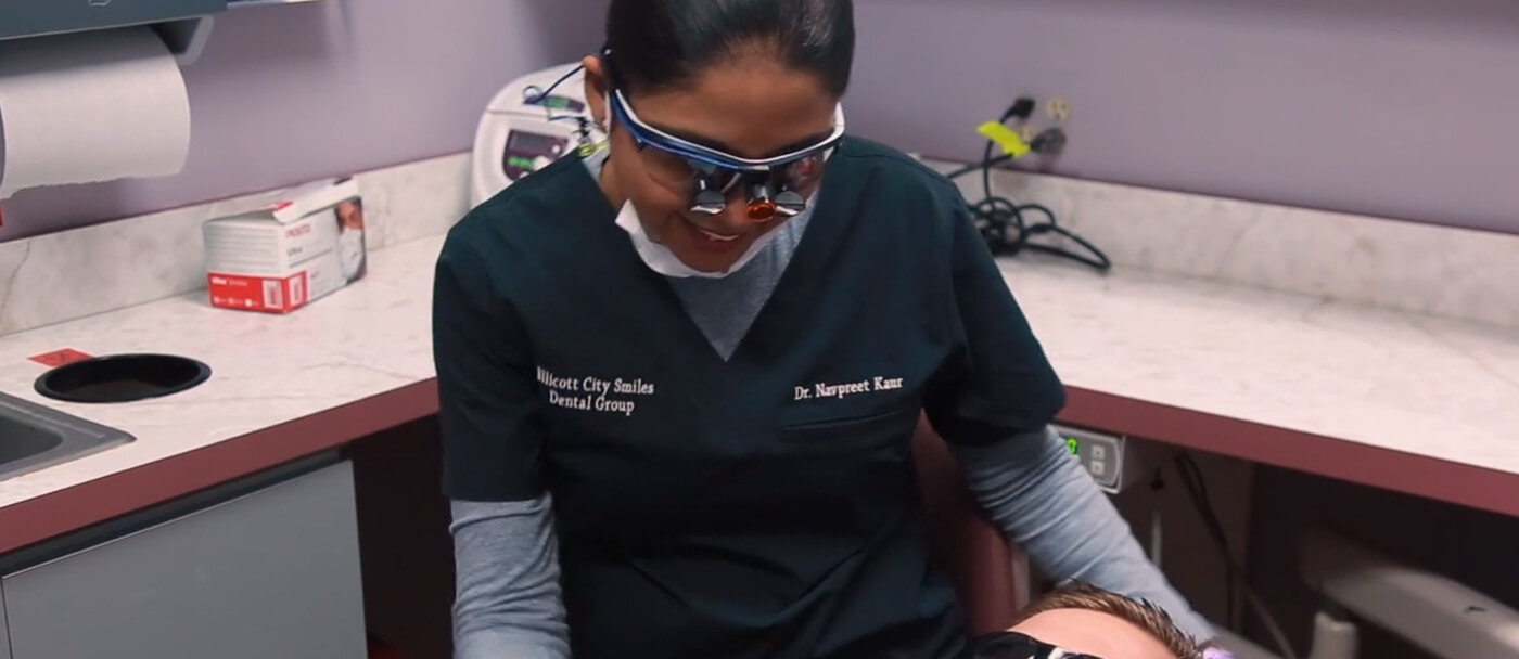 Doctor Khatra smiling at dental patient