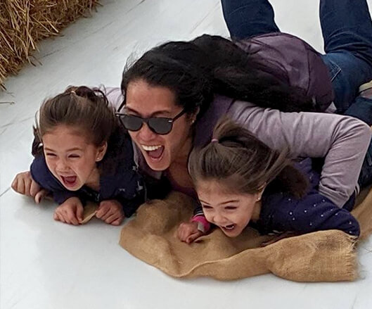 Doctor Tiu and her two daughters sledding