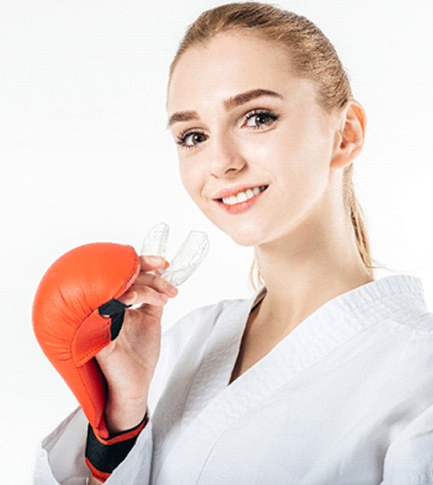 Woman holding mouthguard in San Antonio