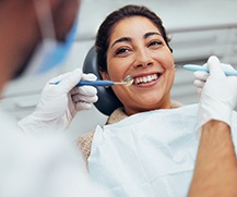 a woman having her teeth examined by her dentist