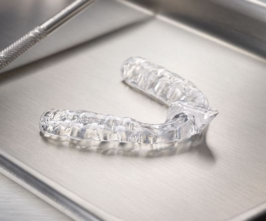 Clear nightguard for bruxism on metal tray