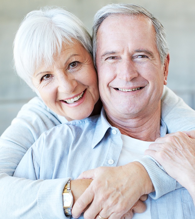 Man and woman smiling together after restorative dentistry