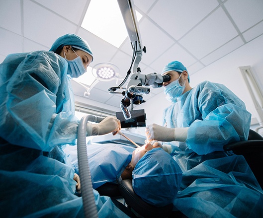two dental specialists doing a surgical procedure