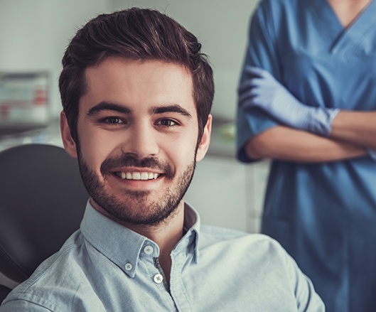 Young man smiling after wisdom tooth extraction