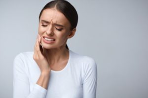 Woman in white shirt having a dental emergency