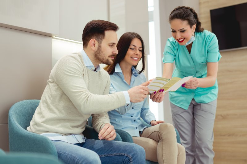 A dentist explaining dental insurance with a patient